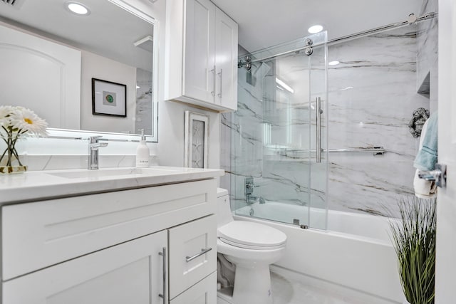 full bathroom featuring vanity, toilet, and combined bath / shower with glass door