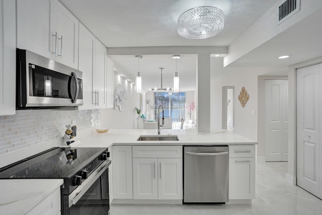 kitchen featuring white cabinetry, stainless steel appliances, sink, and light stone counters