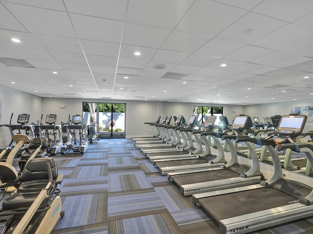 exercise room featuring french doors, a paneled ceiling, and carpet floors