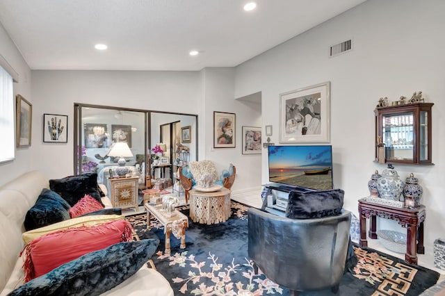 living room featuring lofted ceiling