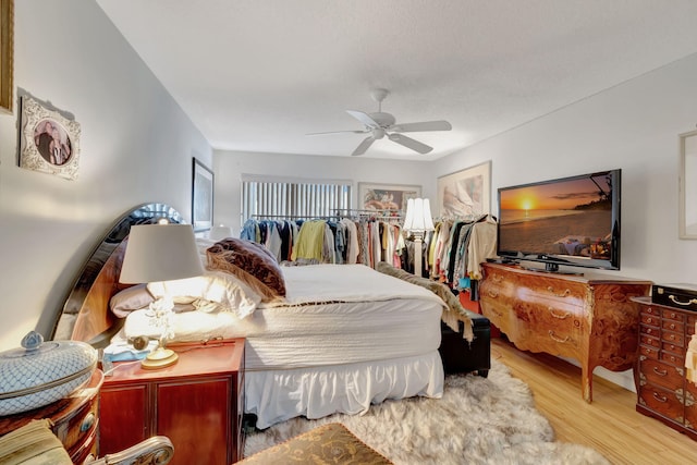 bedroom with ceiling fan and light hardwood / wood-style flooring