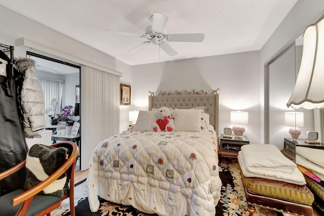 bedroom with a closet, ceiling fan, a textured ceiling, and hardwood / wood-style floors