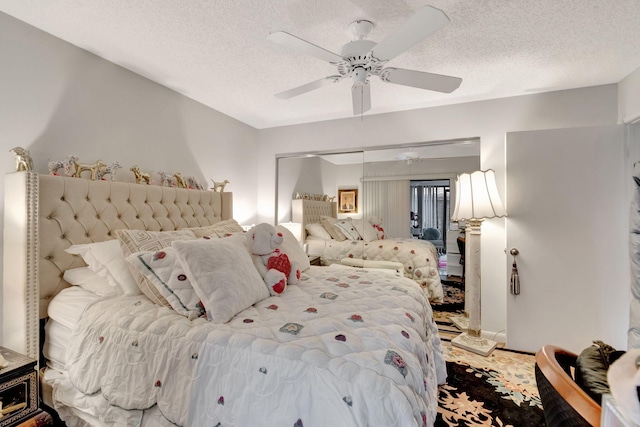 bedroom with a textured ceiling, a closet, and ceiling fan