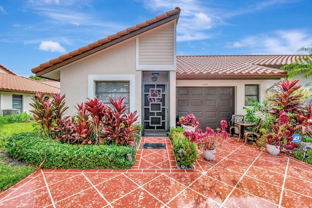 mediterranean / spanish home with central AC and a garage