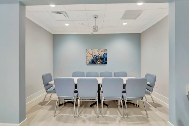 dining space featuring a drop ceiling and hardwood / wood-style flooring