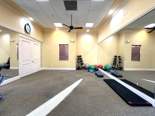 workout room with carpet floors, a drop ceiling, ceiling fan, and ornamental molding