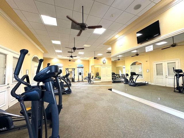 exercise room with french doors, a paneled ceiling, carpet floors, and ornamental molding