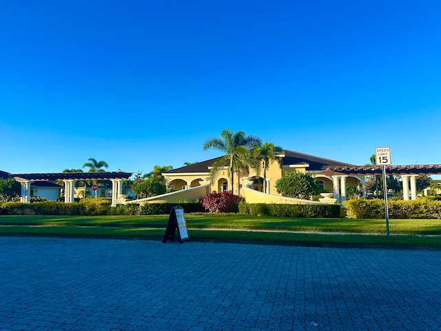 mediterranean / spanish-style house featuring a front yard