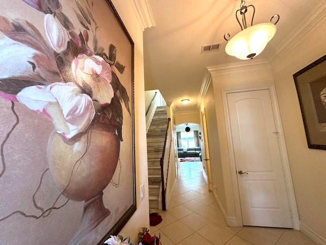 hallway featuring crown molding and light tile patterned floors