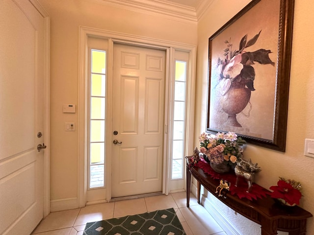 tiled foyer featuring crown molding