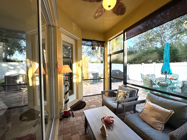 sunroom / solarium featuring ceiling fan