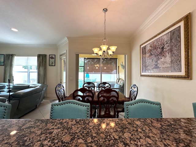 dining space featuring crown molding, light tile patterned floors, and an inviting chandelier