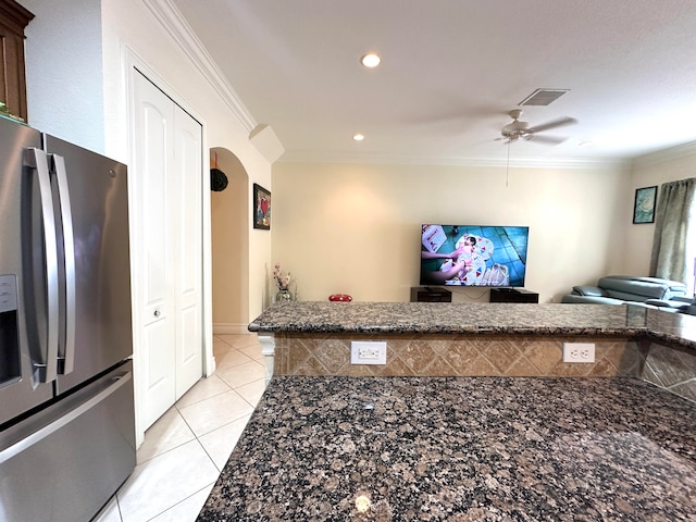 kitchen with stainless steel fridge, light tile patterned floors, ceiling fan, and ornamental molding