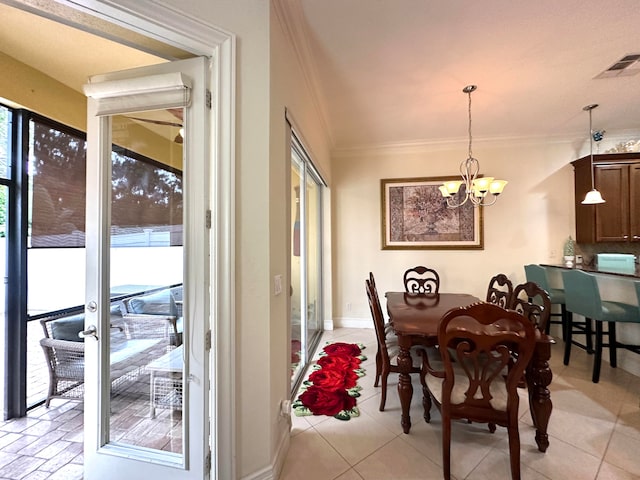 tiled dining area with a chandelier and crown molding