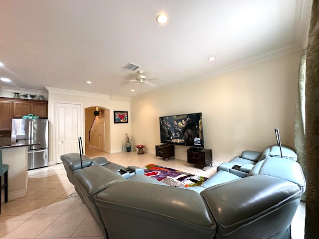 tiled living room featuring ceiling fan and crown molding