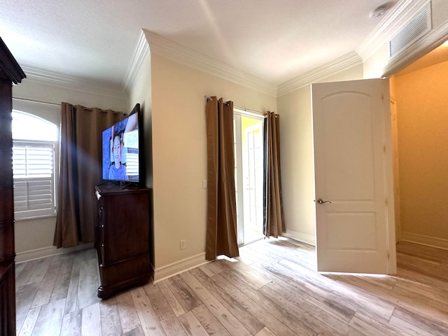 interior space with light hardwood / wood-style floors and ornamental molding