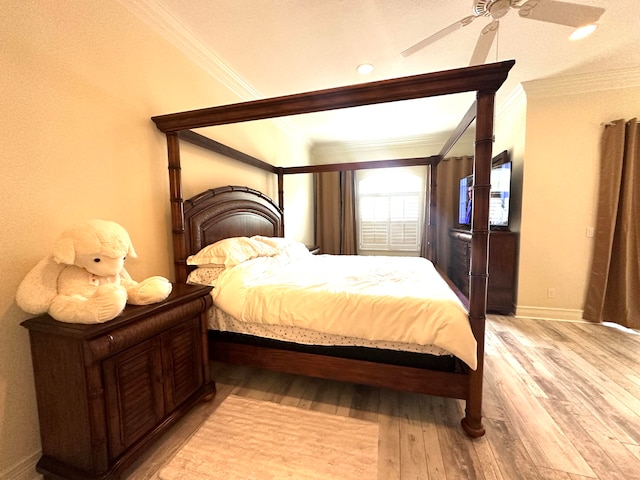 bedroom with light hardwood / wood-style floors, ceiling fan, and ornamental molding