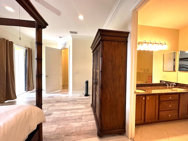 interior space featuring vanity, hardwood / wood-style flooring, and ornamental molding