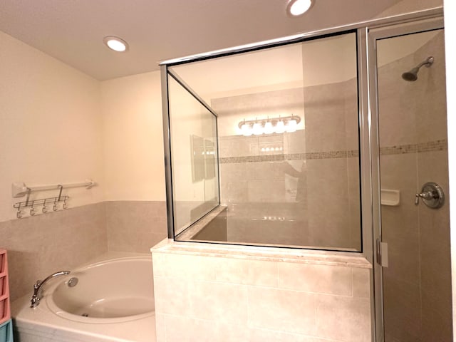 bathroom featuring plus walk in shower and vanity