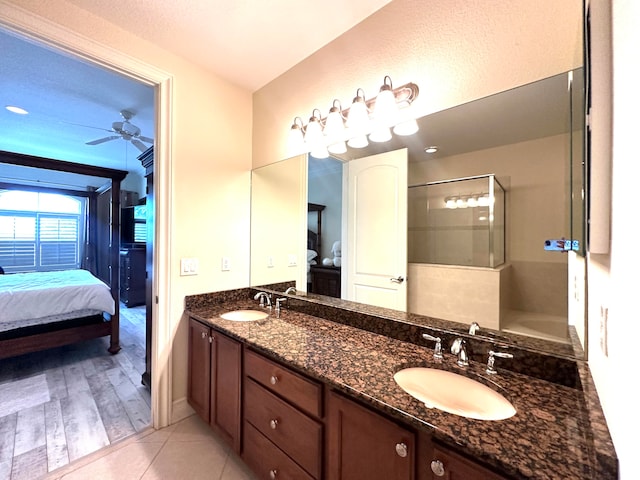 bathroom with ceiling fan, wood-type flooring, walk in shower, and vanity