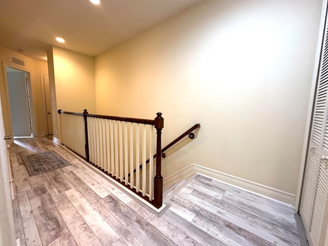 stairway with hardwood / wood-style floors