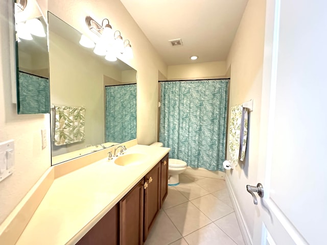 bathroom with tile patterned floors, curtained shower, vanity, and toilet