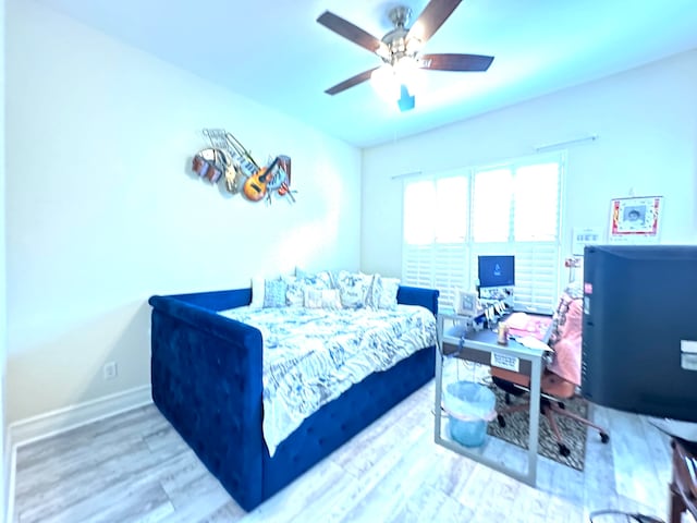 bedroom with wood-type flooring and ceiling fan