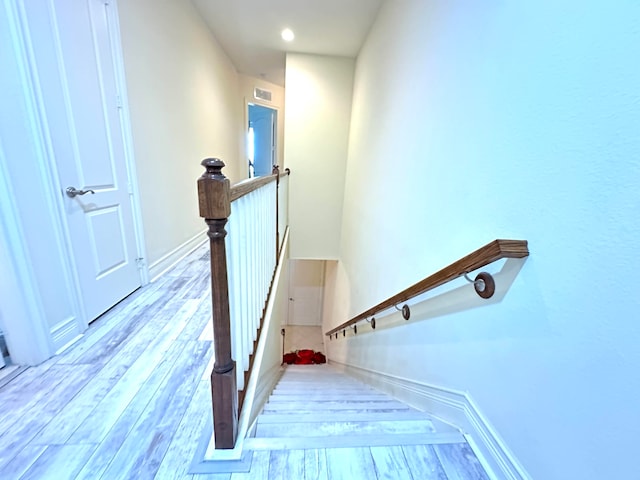 stairs featuring hardwood / wood-style floors