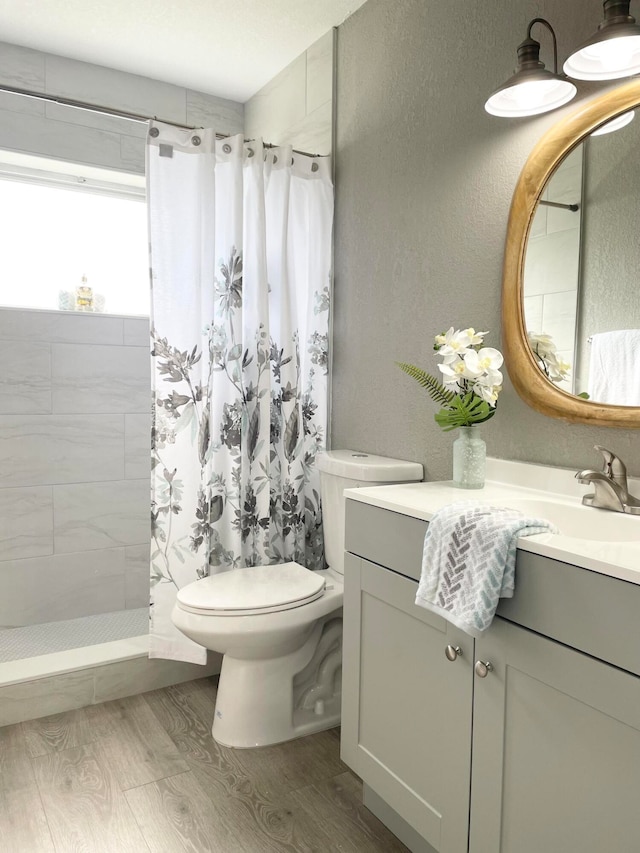 bathroom with vanity, toilet, a shower with shower curtain, and hardwood / wood-style floors