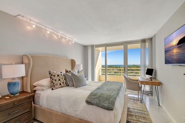 bedroom featuring light tile patterned floors, access to outside, and track lighting