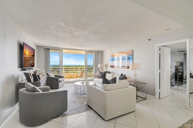 tiled living room featuring floor to ceiling windows