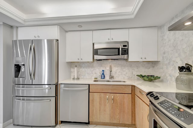 kitchen featuring light brown cabinets, sink, a tray ceiling, white cabinetry, and stainless steel appliances