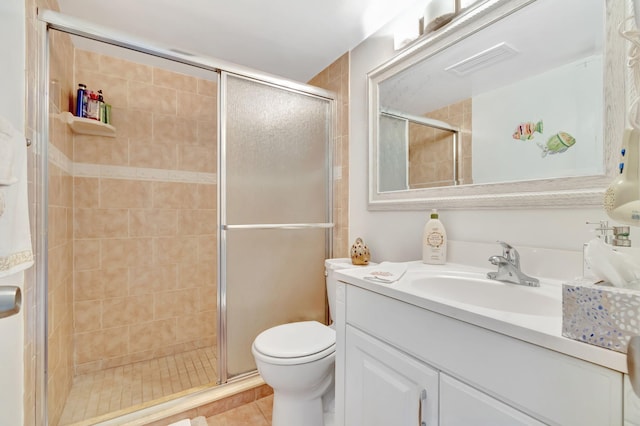 bathroom featuring vanity, tile patterned flooring, toilet, and an enclosed shower