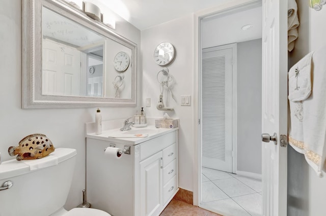 bathroom featuring vanity, toilet, and tile patterned floors