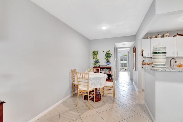 dining space with sink and light tile patterned floors