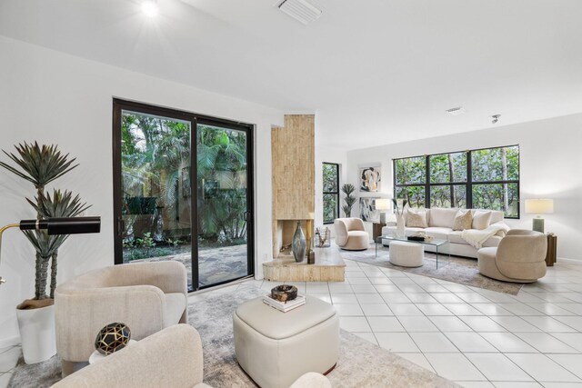 tiled living room with ceiling fan