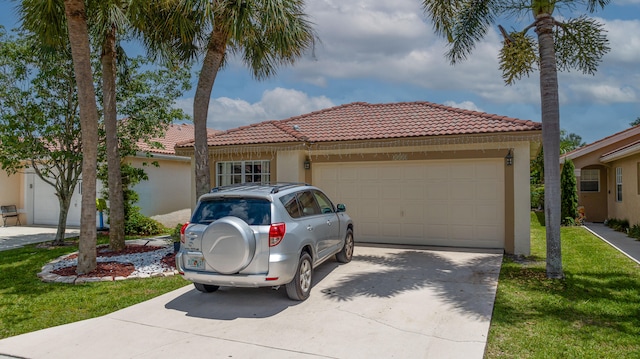 mediterranean / spanish home featuring a front yard and a garage