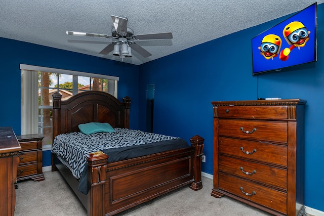 bedroom with light carpet, a textured ceiling, and ceiling fan