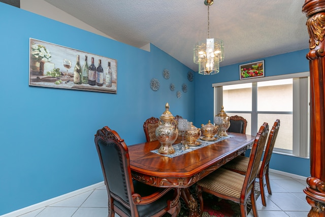 dining room with an inviting chandelier, a textured ceiling, and light tile patterned floors