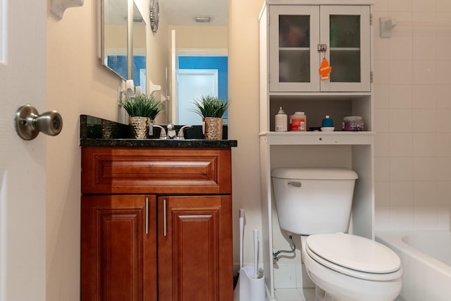 bathroom with vanity, toilet, and tile patterned floors