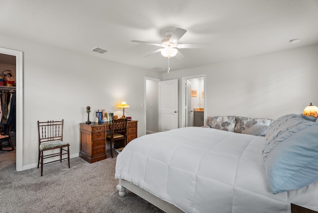 bedroom with carpet flooring, a spacious closet, a closet, and ceiling fan