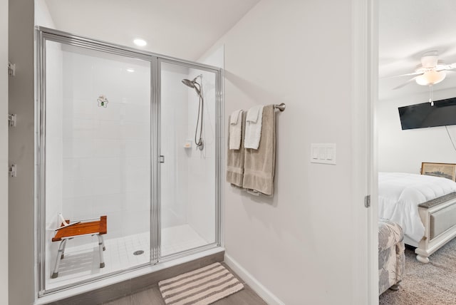 bathroom featuring walk in shower and ceiling fan