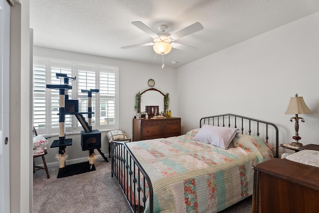 bedroom featuring a textured ceiling, ceiling fan, and light carpet