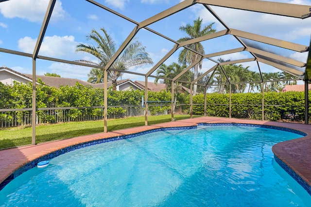 view of swimming pool featuring a lanai and a yard