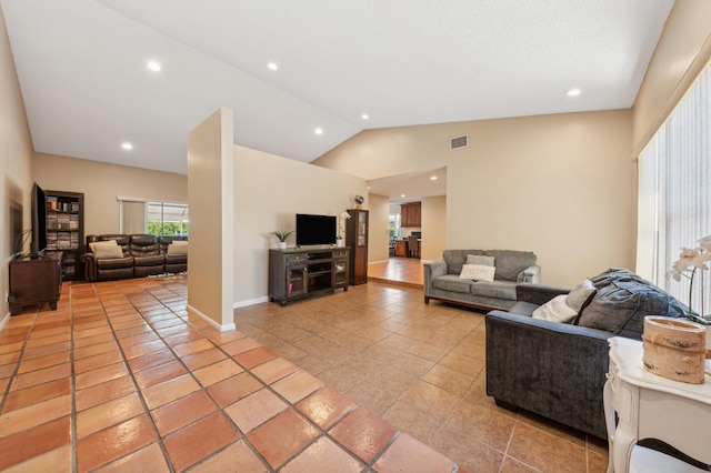 living room featuring high vaulted ceiling and light tile patterned floors