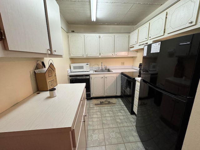 kitchen with sink and black appliances