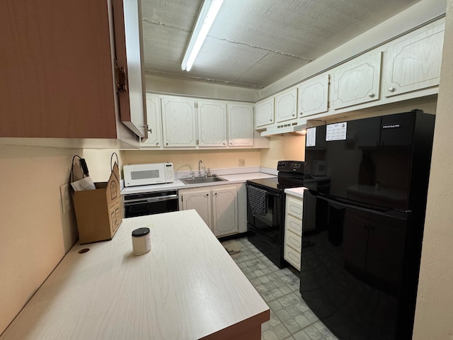 kitchen with white cabinets, sink, and black appliances