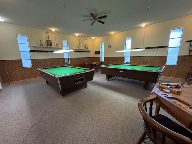 recreation room featuring wood walls, carpet, and ceiling fan