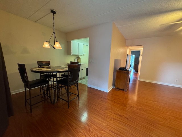 dining area featuring a textured ceiling and hardwood / wood-style flooring