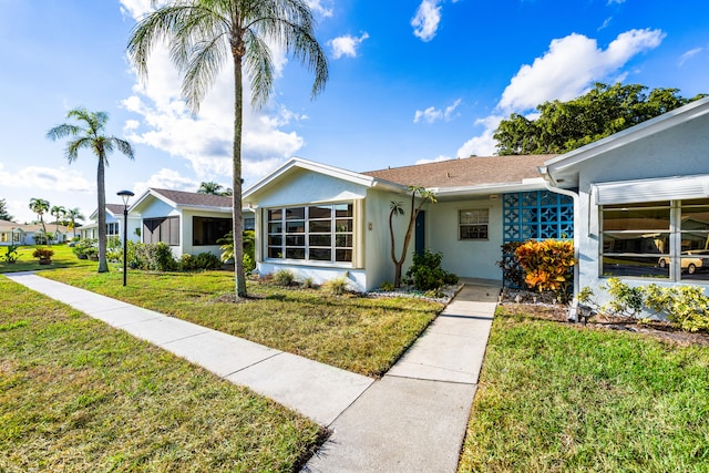 ranch-style house with a front lawn